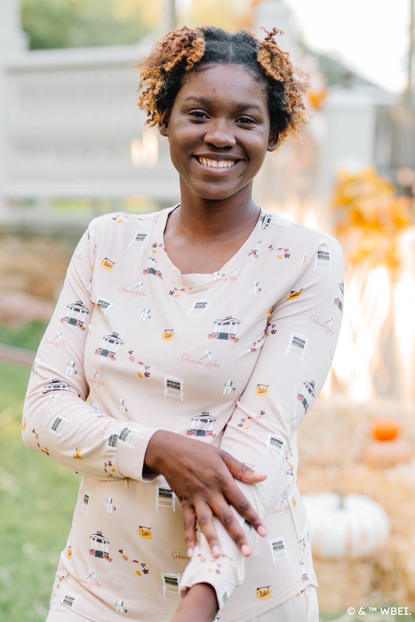 Smiling model with her hand on her arm wearing the Women's Jogger Pajama Set in Gilmore
