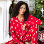 Woman sitting down with one leg propped up and the other bent in with her arm on her knee in long sleeve pajama set in gingerbread print

::: Model is 5'10" wearing size XS Tall ///
---PJ 4