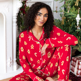 Woman sitting down with one leg propped up and the other bent in with her arm on her knee in long sleeve pajama set in gingerbread print

::: Model is 5'10" wearing size XS Tall ///
---PJ 4