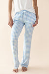 Person wearing blue and white checkered pajama pants on a beige background ::: Model is 5'11" wearing size S ///