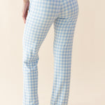 Light blue gingham check pants worn by a person on a beige background