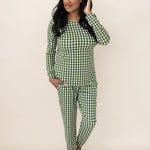 Model standing in front of a beige wall wearing the Bamboo Women's Jogger Pajama Set in Gingham Fir