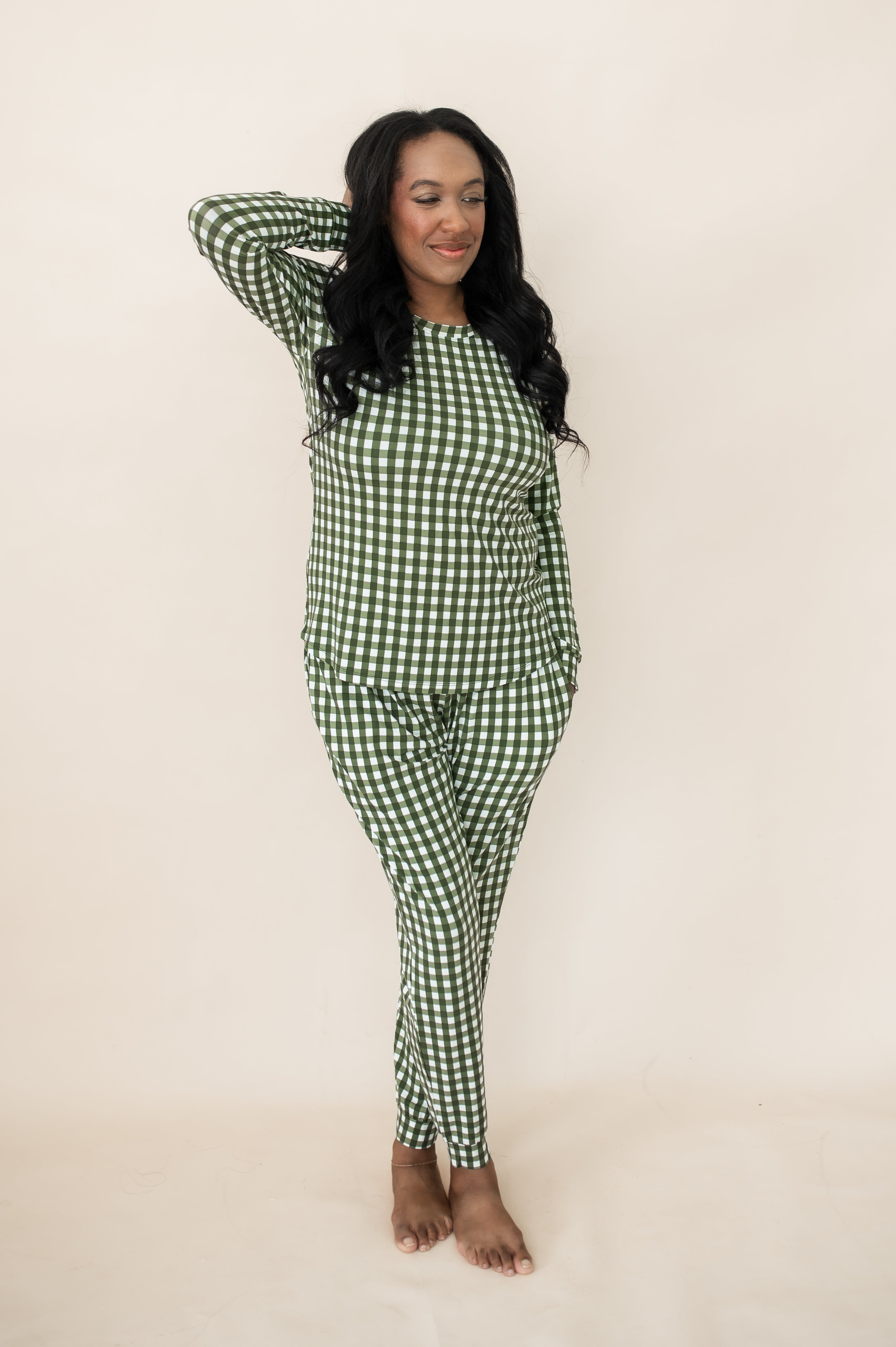 Model with hand in hair while wearing the Bamboo Women's Jogger Pajama Set in Gingham Fir
