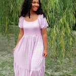 Women’s Smocked Dress in a light purple checkered pattern in an outdoor setting