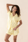 Woman wearing a yellow checkered pajama set against a beige background ::: Model is 5'3" wearing size XS ///