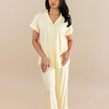 Woman wearing a yellow checkered pajamas against a beige background   ::: Model is 5' wearing size XS ///