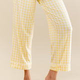 Yellow checkered pants worn by a person on a beige background