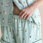Model showcasing the shorts of  Women's Short Sleeve Pajama Set in Golf print on beige background