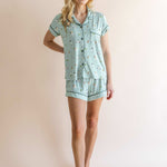 Model wearing Women's Short Sleeve Pajama Set in Golf print on beige background