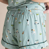 Model showing the back of Women's Short Sleeve Pajama Set shorts in Golf print on beige background