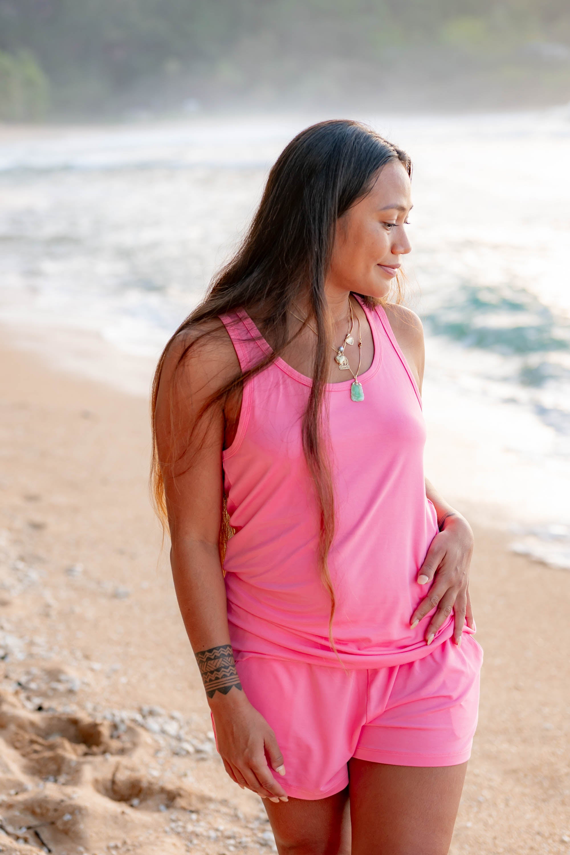 Female model wearing the Women’s Tank Set in Guava