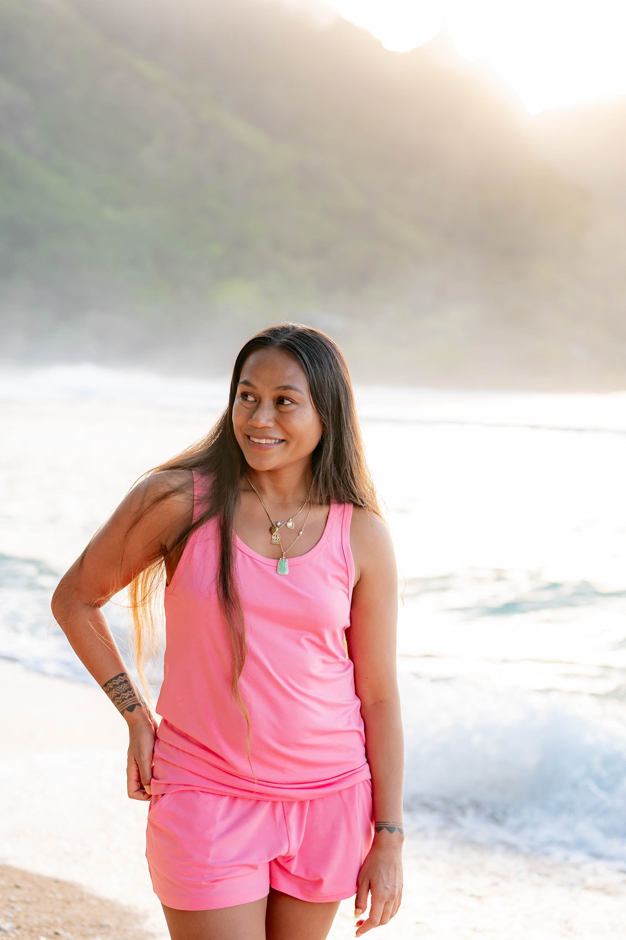 Smiling model wearing the Women’s Tank Set in Guava