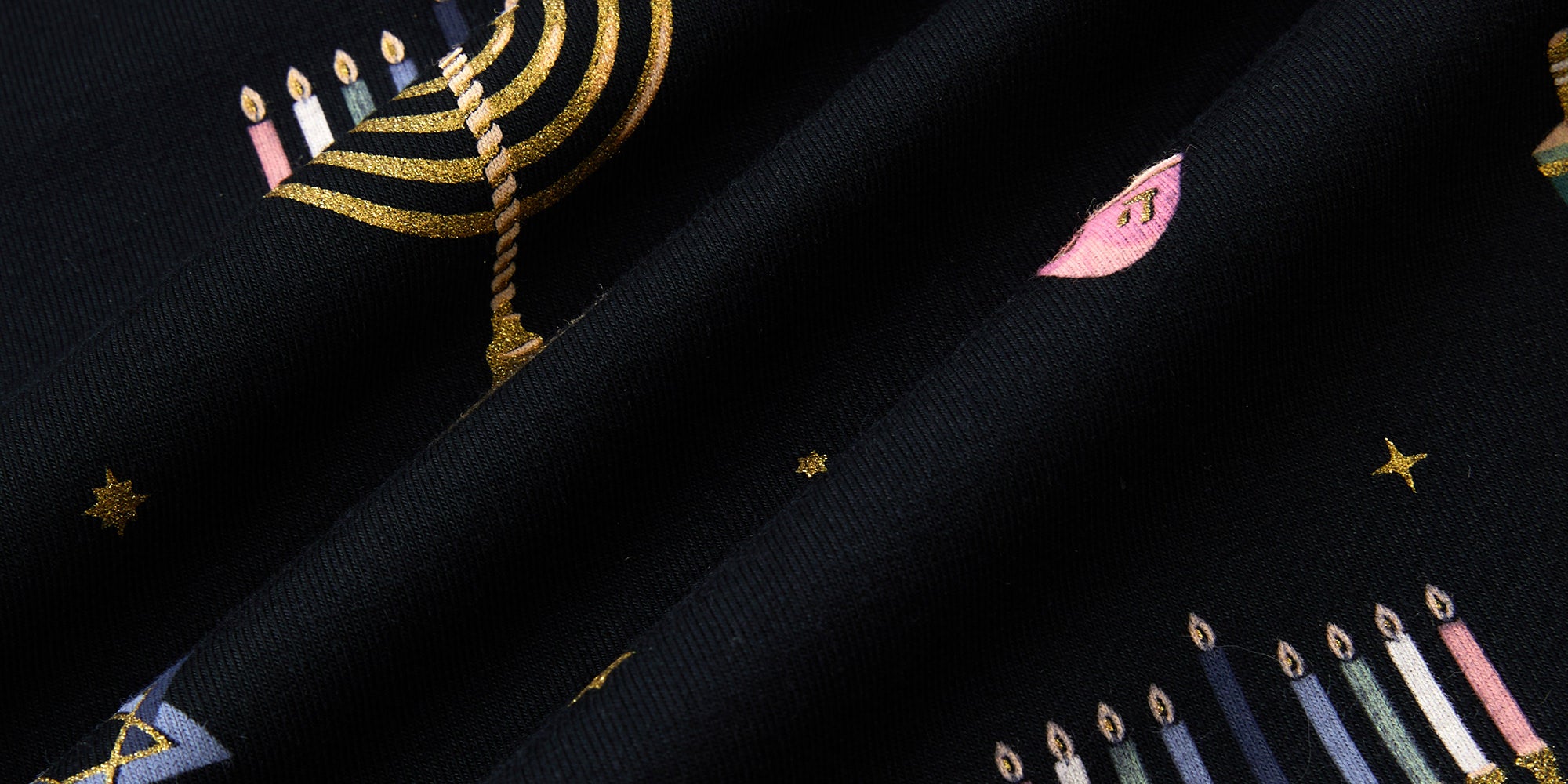 Black fabric with Hanukkah elements printed 