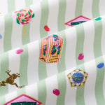 Close up of Green and white striped fabric with colorful Honeydukes Harry Potter pattern print
