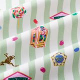 Close up of Green and white striped fabric with colorful Honeydukes Harry Potter pattern print