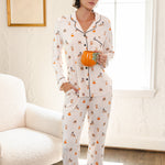 Modal wearing Beige Long-Sleeved Women's Pajama Set in Halloween Teddy print holding a mug standing in a living room ::: Model is 5'10" wearing size XS ///