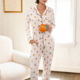 Modal wearing Beige Long-Sleeved Women's Pajama Set in Halloween Teddy print holding a mug standing in a living room ::: Model is 5'10" wearing size XS ///