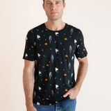 Modal posing wearing Men's Crew Neck Tee in Halloween Friends print over blue jeans on a beige background ::: Model is 6'2" wearing size M ///
