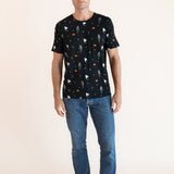 Modal wearing Men's Crew Neck Tee in Halloween Friends print over blue jeans on a beige background