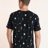Back side of Modal wearing Men's Crew Neck Tee in Halloween Friends print over blue jeans on a beige background