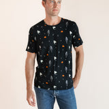 Modal posing in Men's Crew Neck Tee in Halloween Friends print over blue jeans on a beige background