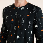 Close up of Modal wearing Men's Jogger Set in Halloween Friends print on beige background