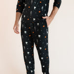 Modal wearing Men's Jogger Set in Halloween Friends print with hand in pocket on beige background