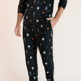 Modal wearing Men's Jogger Set in Halloween Friends print with hand in pocket on beige background