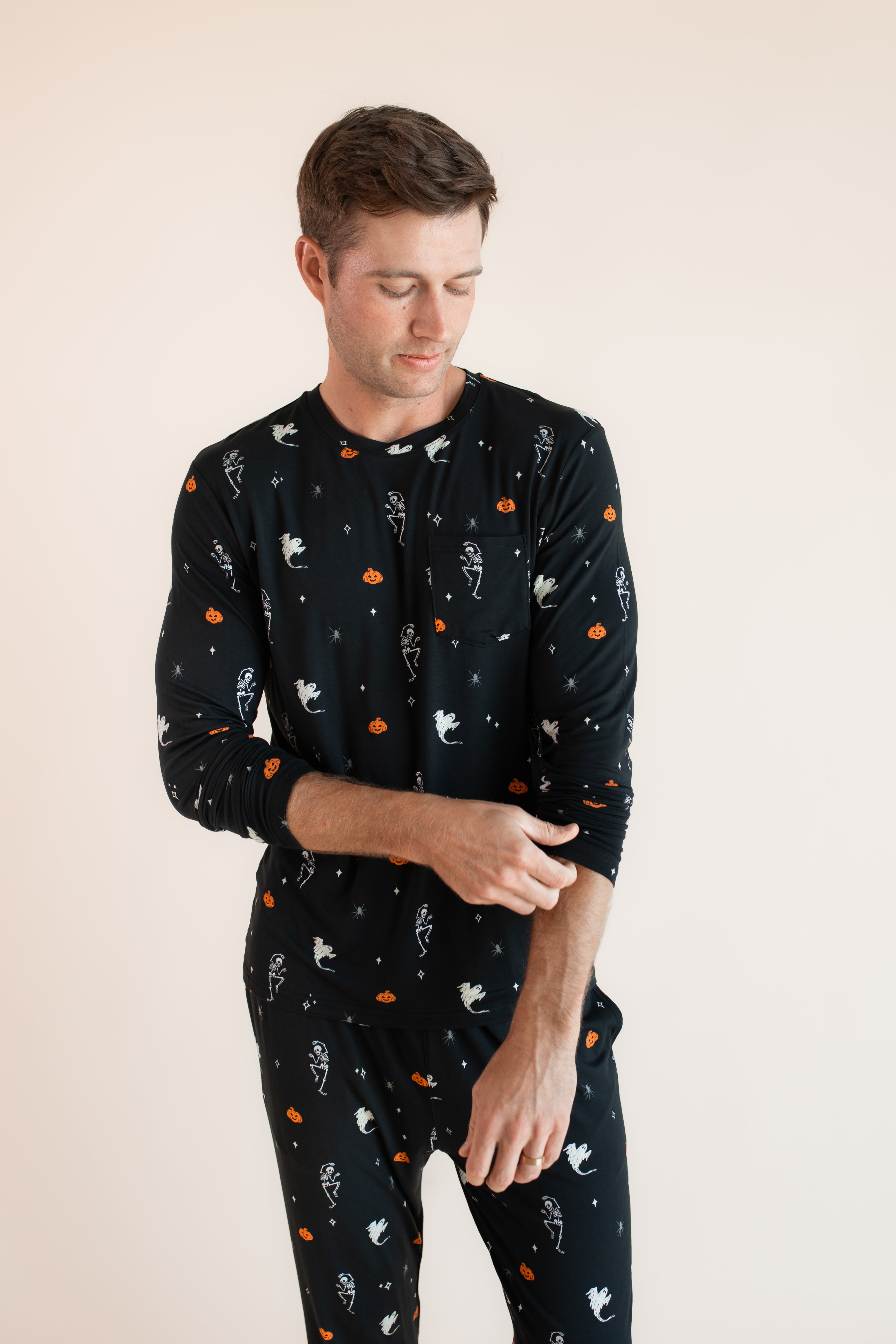 Modal posing in Men's Jogger Set in Halloween Friends print on beige background