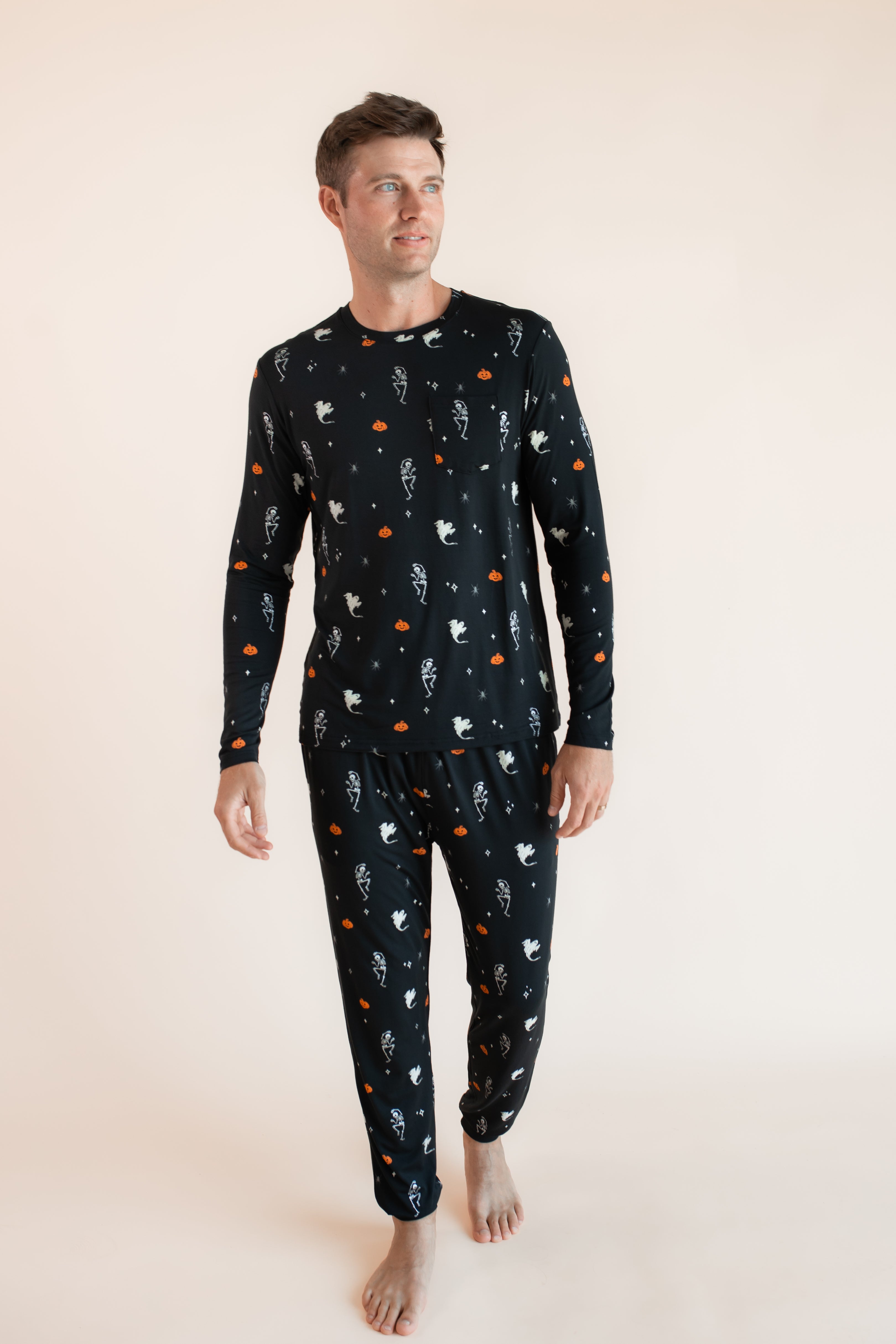 Modal wearing Men's Jogger Set in Halloween Friends print on beige background