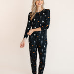 Modal posing in Women's Jogger Pajama Set in Halloween Friends print on a beige background