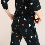 Back side of Modal wearing Women's Jogger Pajama Set in Halloween Friends print on a beige background