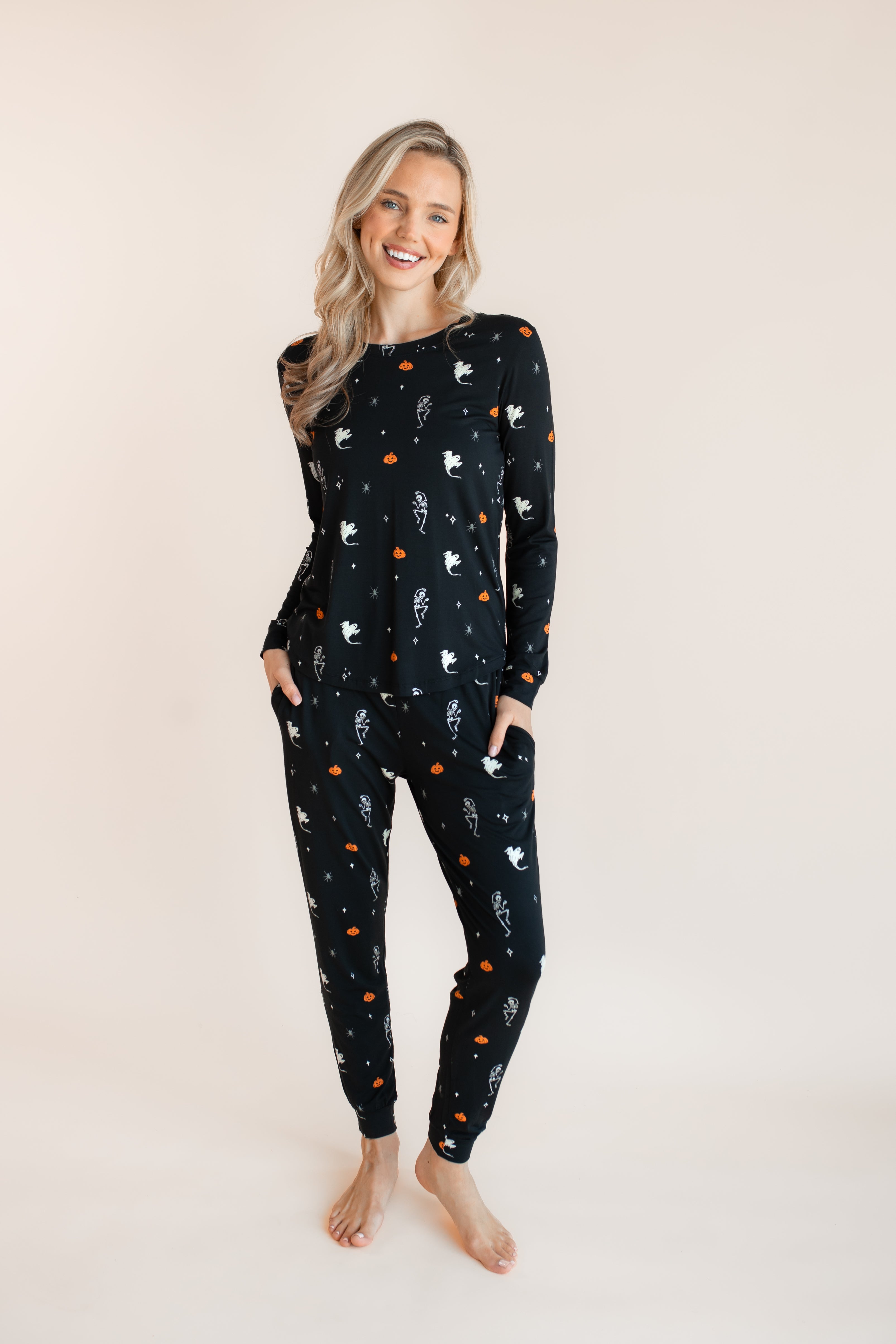 Modal wearing Women's Jogger Pajama Set in Halloween Friends print on a beige background 