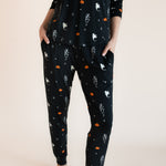 Close up of Modal wearing Women's Jogger Pajama Set in Halloween Friends print on a beige background