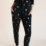 Close up of Modal wearing Women's Jogger Pajama Set in Halloween Friends print on a beige background