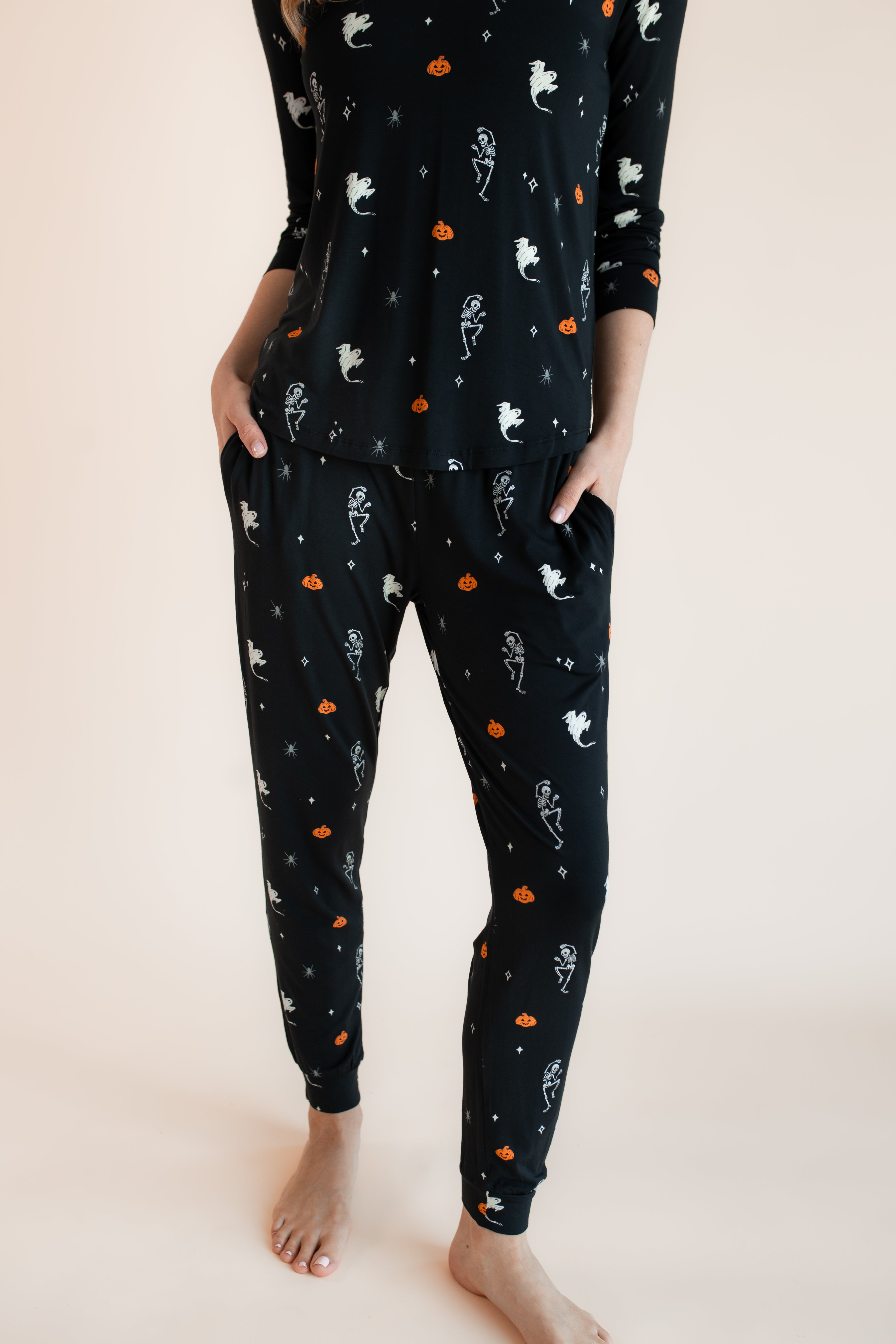 Close up of Modal wearing Women's Jogger Pajama Set in Halloween Friends print on a beige background