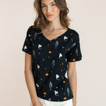 Modal wearing Women's Oversized V-Neck Tee in Halloween Friends print over white pants on a beige background ::: Model is 5'9.5" wearing size XS ///