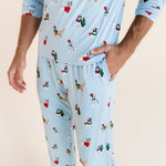 Man showcasing the pockets on Men's Jogger Set in Holiday Pups print on a beige background