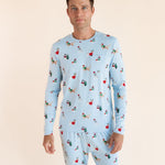 Man wearing Men's Jogger Set in Holiday Pups print on a beige background