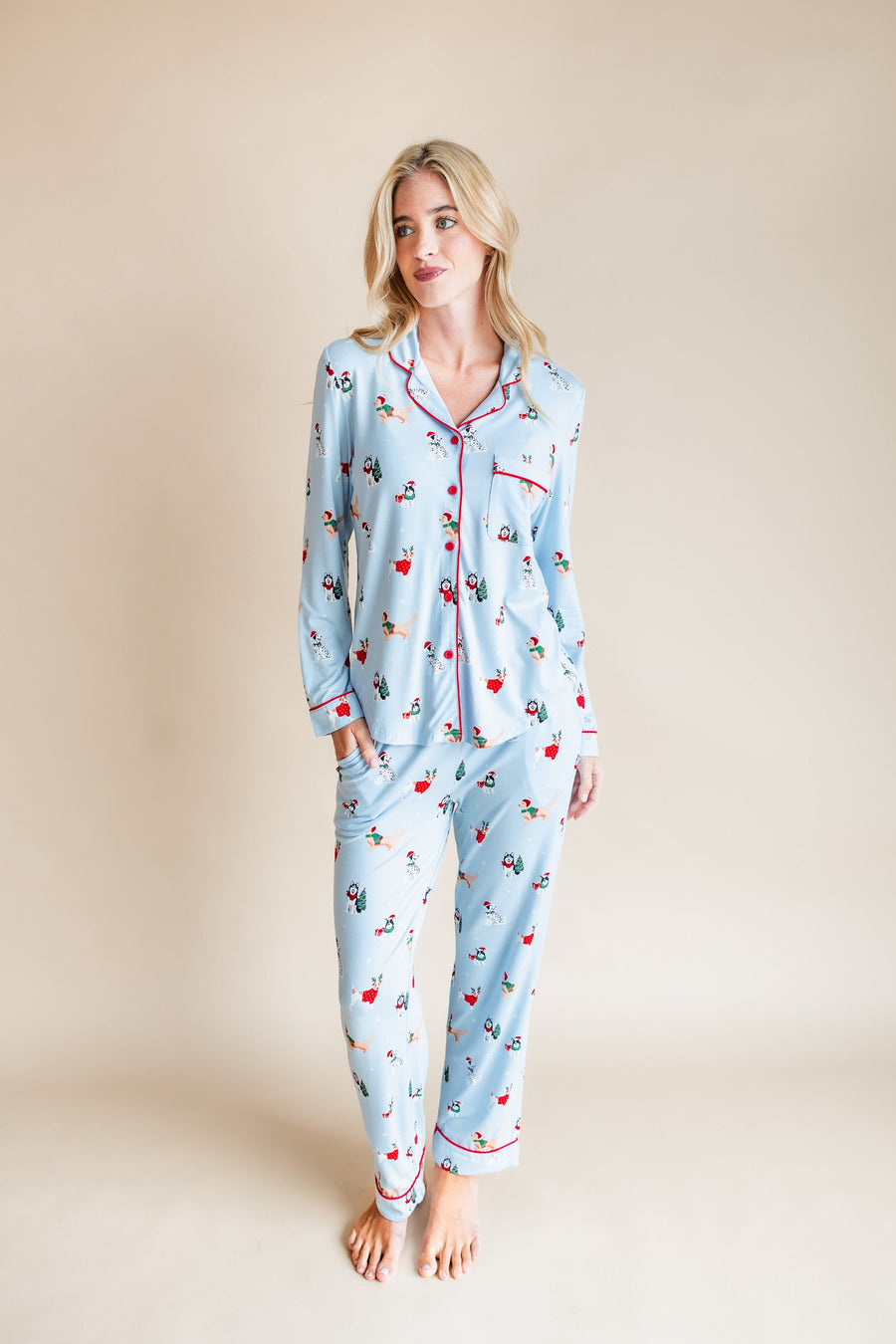 Woman wearing Long-Sleeved Women's Pajama Set in Holiday Pups print on a beige background