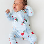 Baby wearing Zippered Romper in Holiday Pups print on a white background