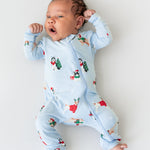 Baby wearing Zippered Romper in Holiday Pups print on a white background