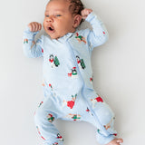 Baby wearing Zippered Romper in Holiday Pups print on a white background