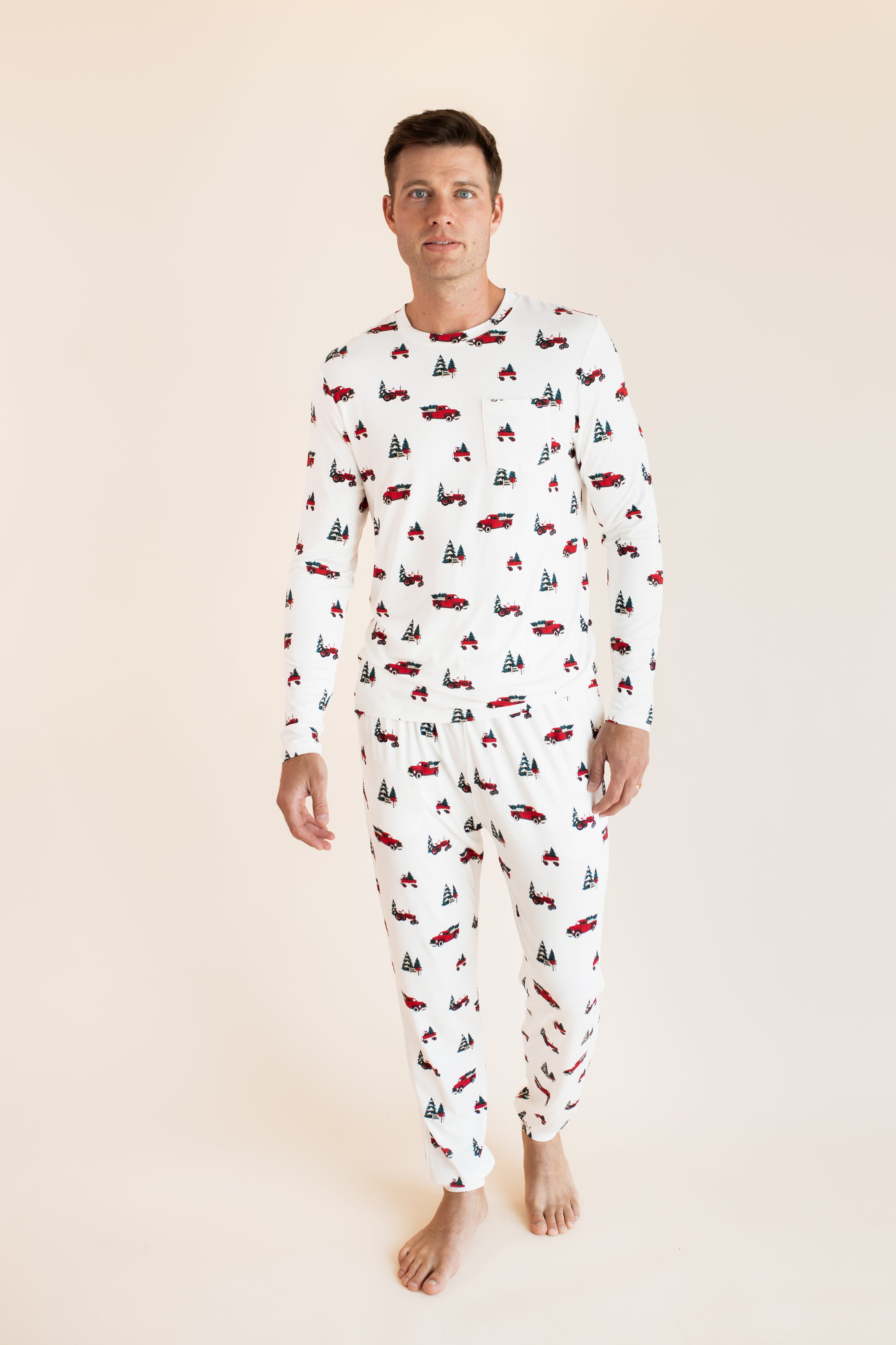 Man walking wearing a jogger set in holiday tree farm
