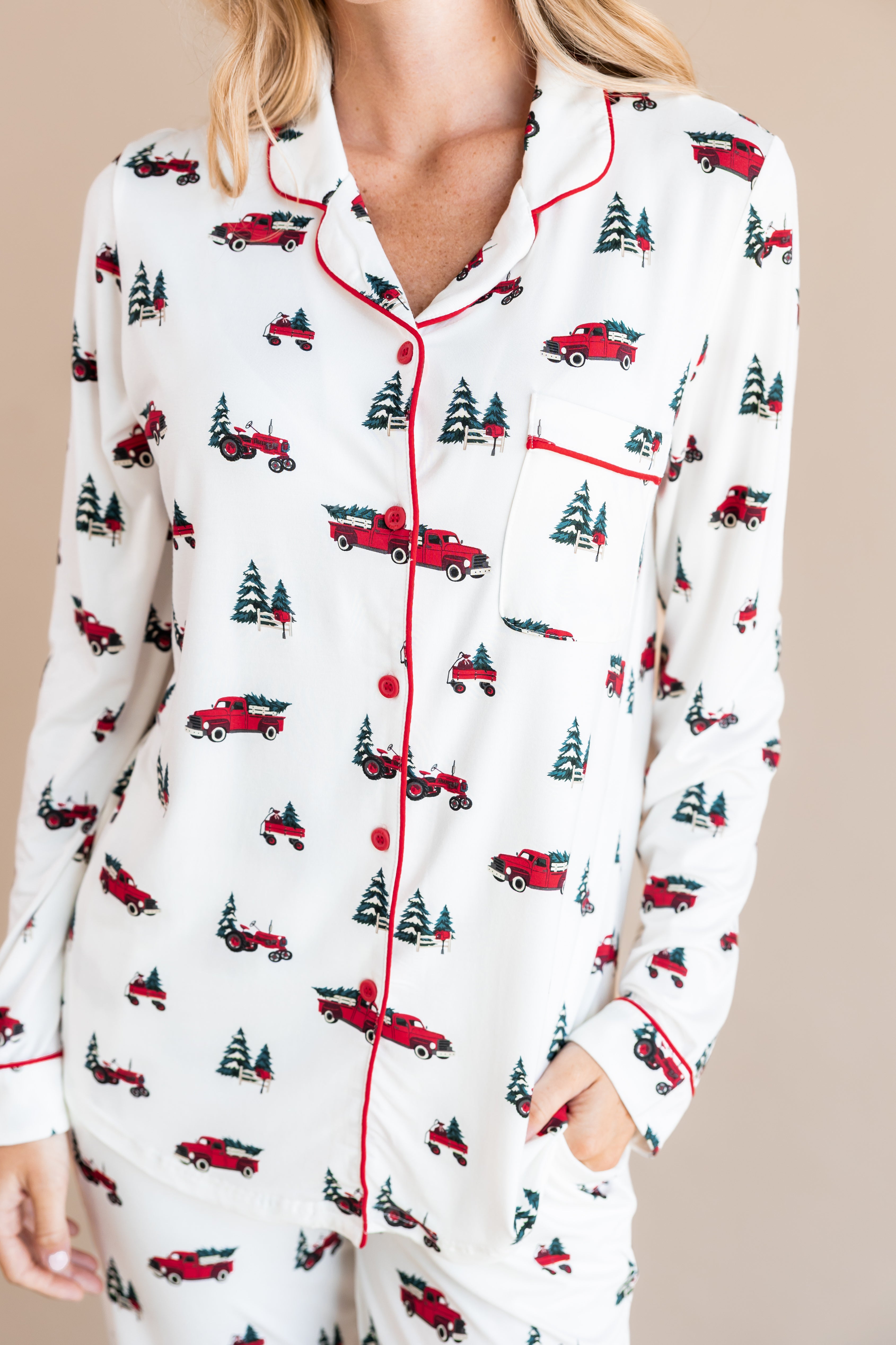 top part of a woman with her hand in her pant pocket wearing long sleeve pajama set in holiday tree farm
---PJ 2