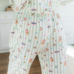 Back side of Long-Sleeved Women's Pajama Set pajamas with colorful Harry Potter patterns on a green and white striped fabric