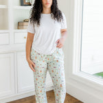 Model standing in a white walled  room and window while wearing the Women's Lounge Pants in Honey dukes paired with a Crew Neck in Cloud 
::: Model is 5'9" wearing size L ///

