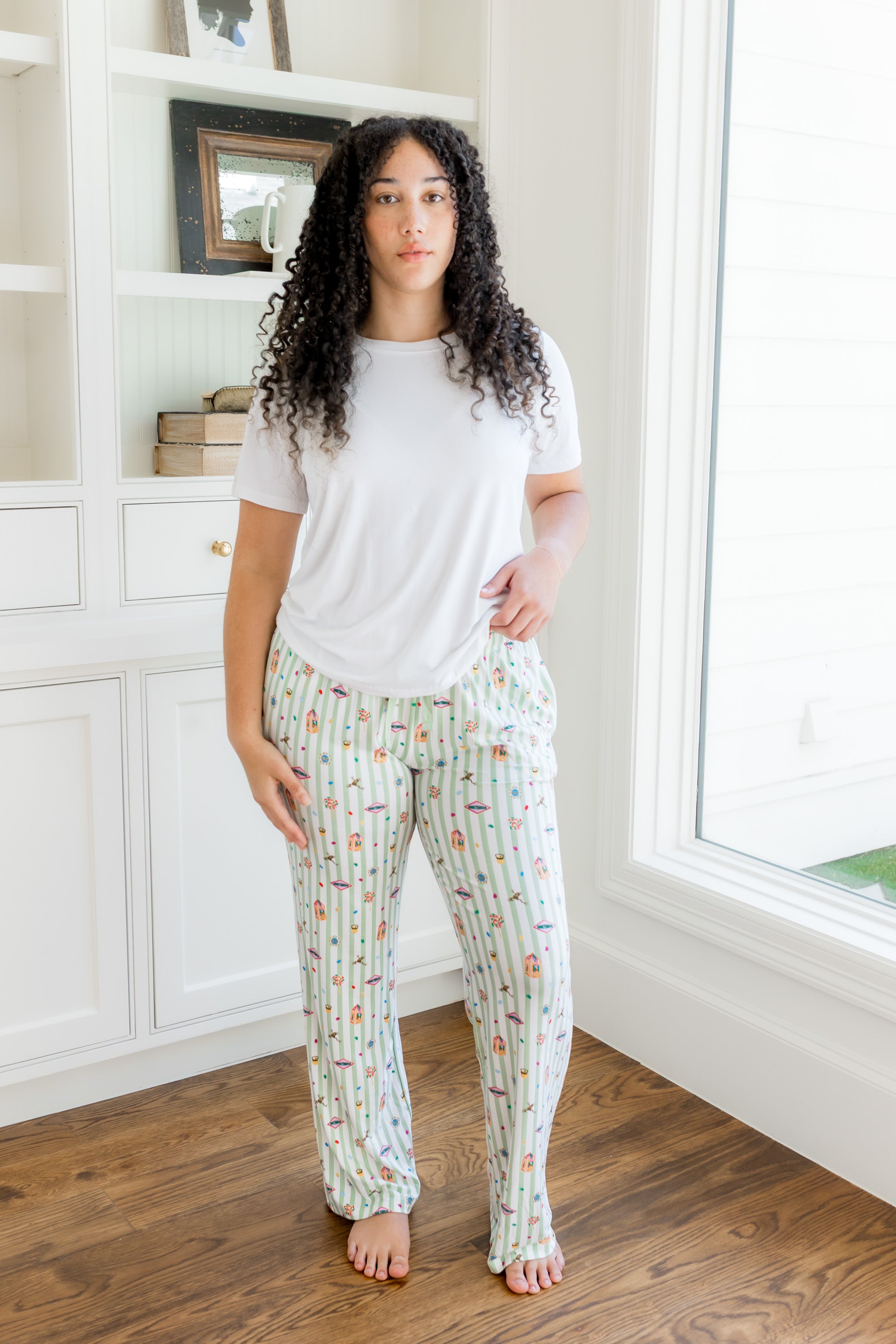 Model standing in a white walled  room and window while wearing the Women's Lounge Pants in Honey dukes paired with a Crew Neck in Cloud 
::: Model is 5'9" wearing size L ///

