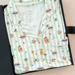 Long-Sleeved Women's Pajama Set in Honeydukes print packed in a box on a beige background