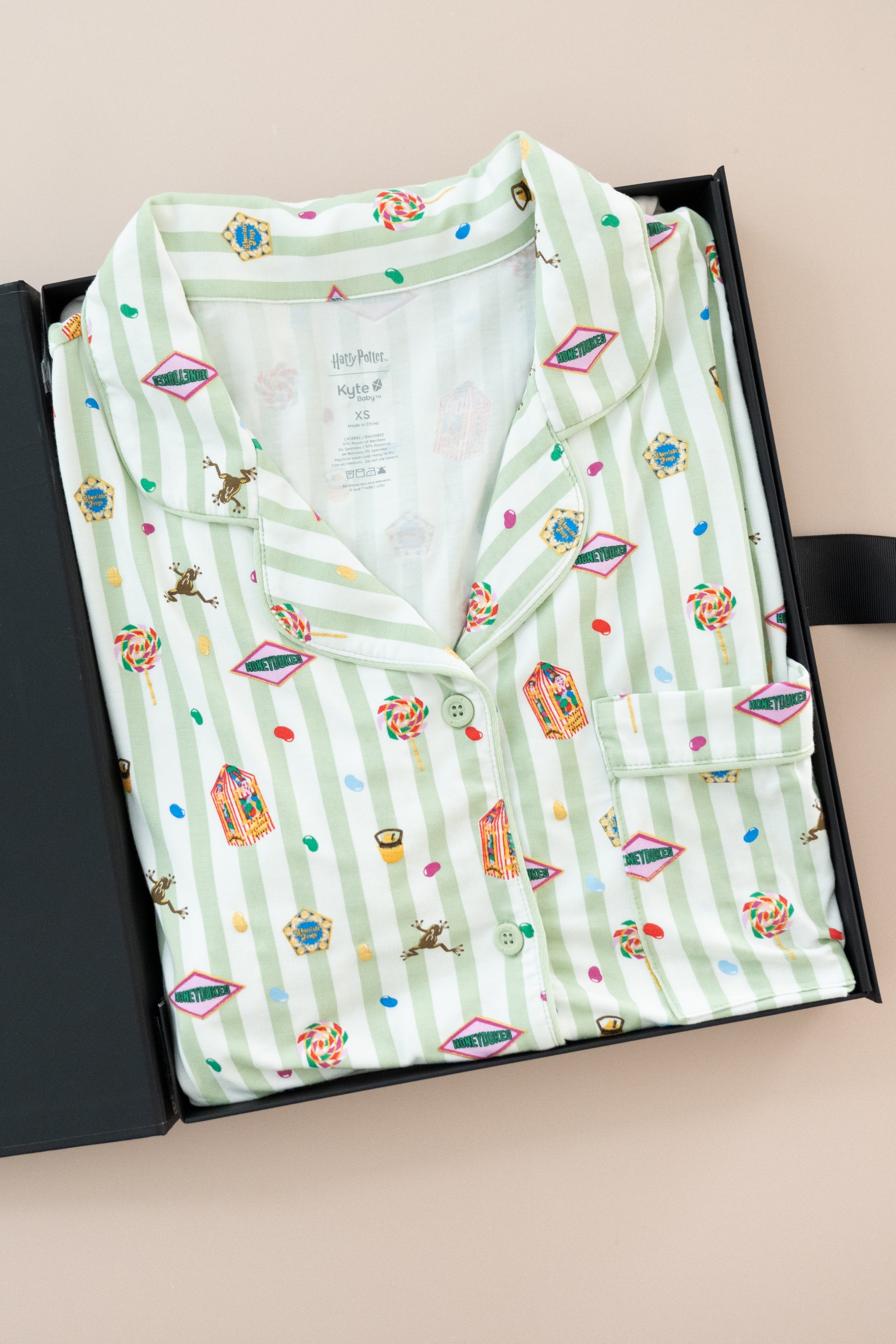 Long-Sleeved Women's Pajama Set in Honeydukes print packed in a box on a beige background